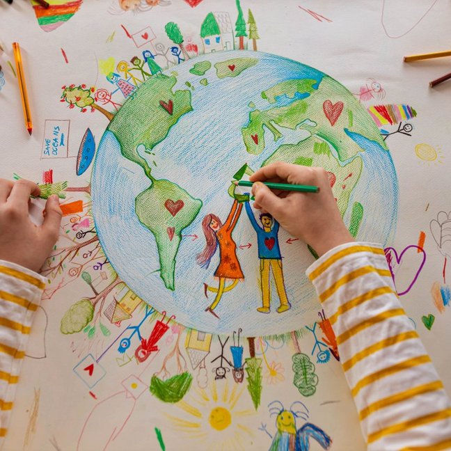 High angle view of unrecognizable boy draw the planet Earth with people