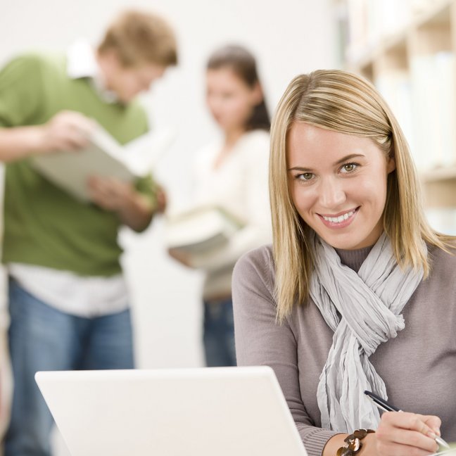 High school library - happy student with laptop